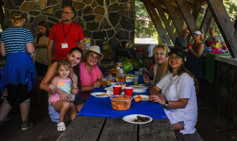 family sitting at picnic table