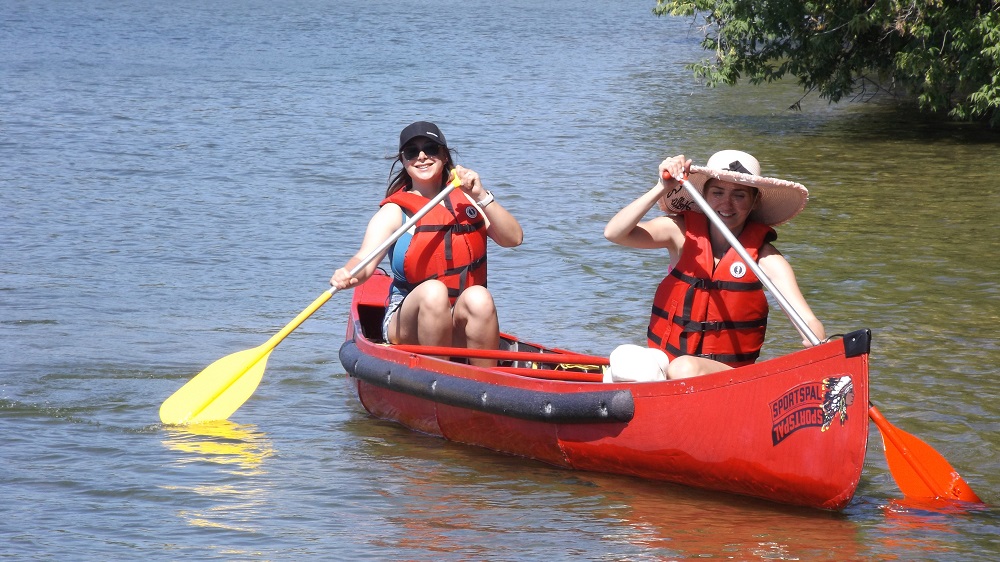 two people paddling in canoe