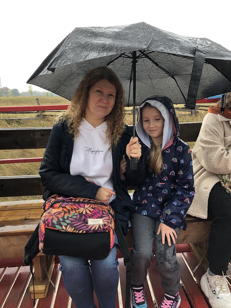 parent and child holding umbrella