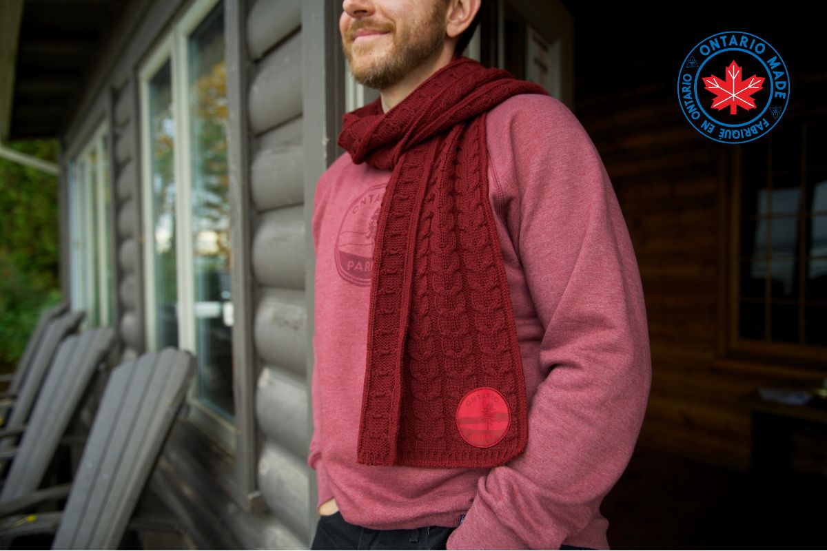 Man wearing red sweatshirt and red scarf. MadeLocal logo on corner