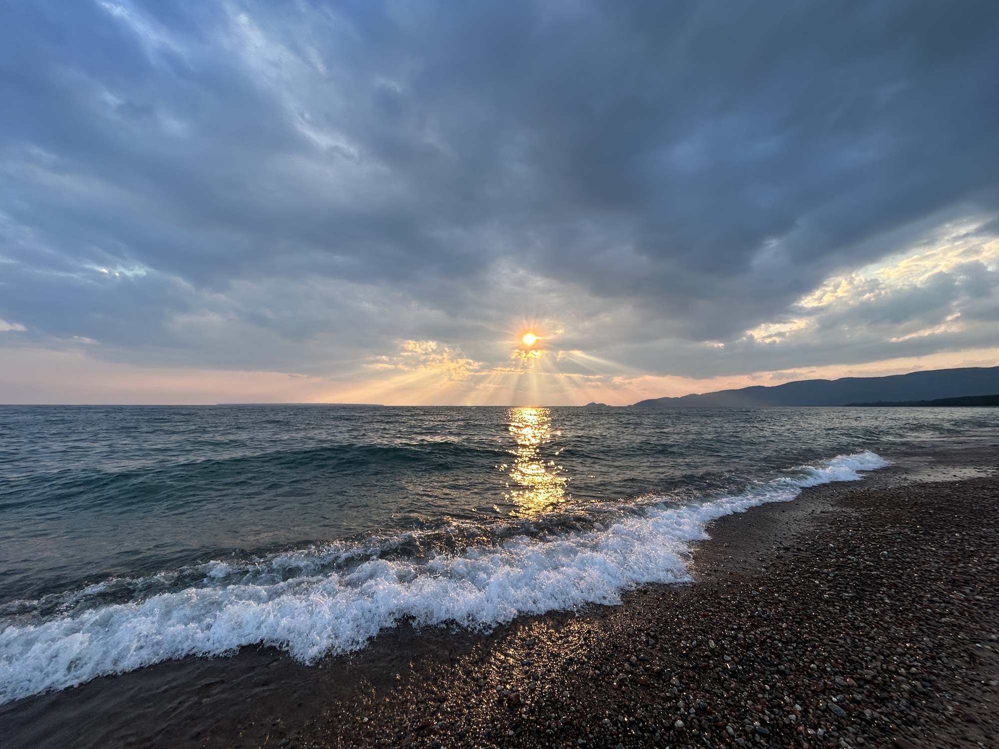 sunset over lake with waves