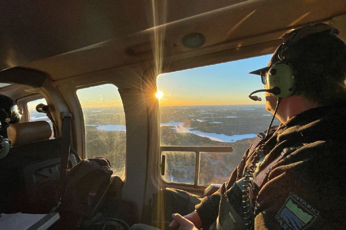 staff in helicopter, looking down over park landscape