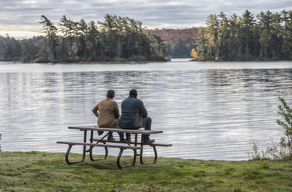 Couple viewing landscape sitting on picnic table