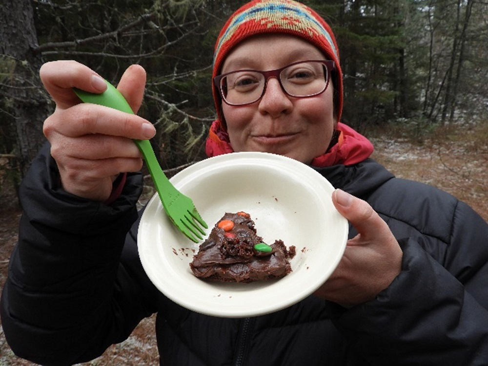 woman holding brownie on plate