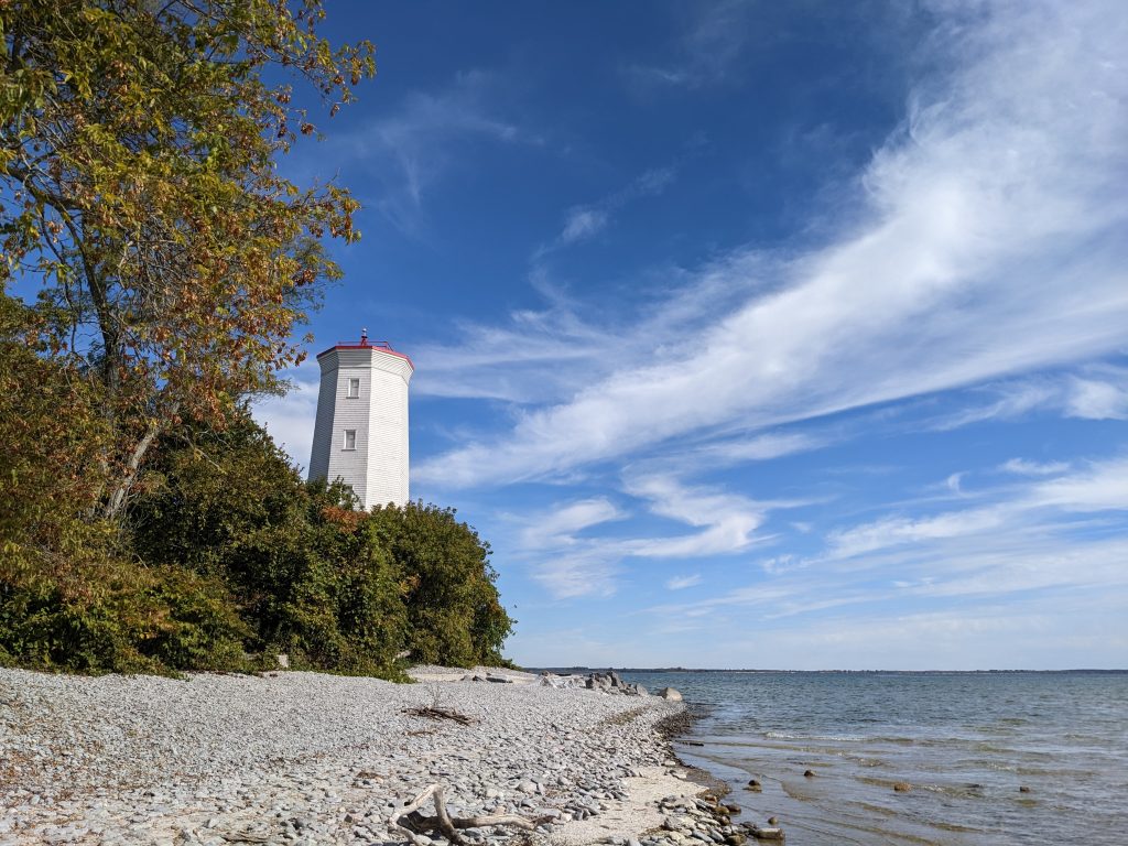 view of lighthouse along rocky shore