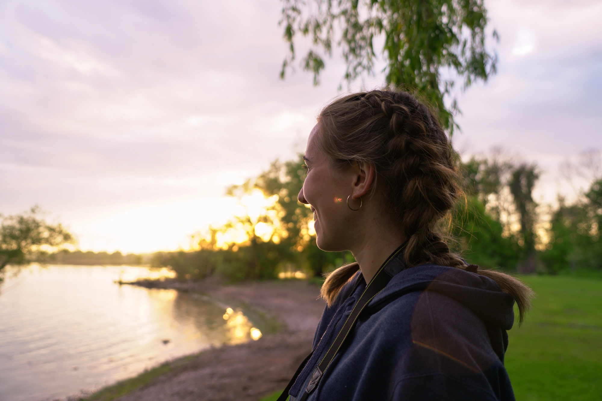 person smiling while looking at the sunset