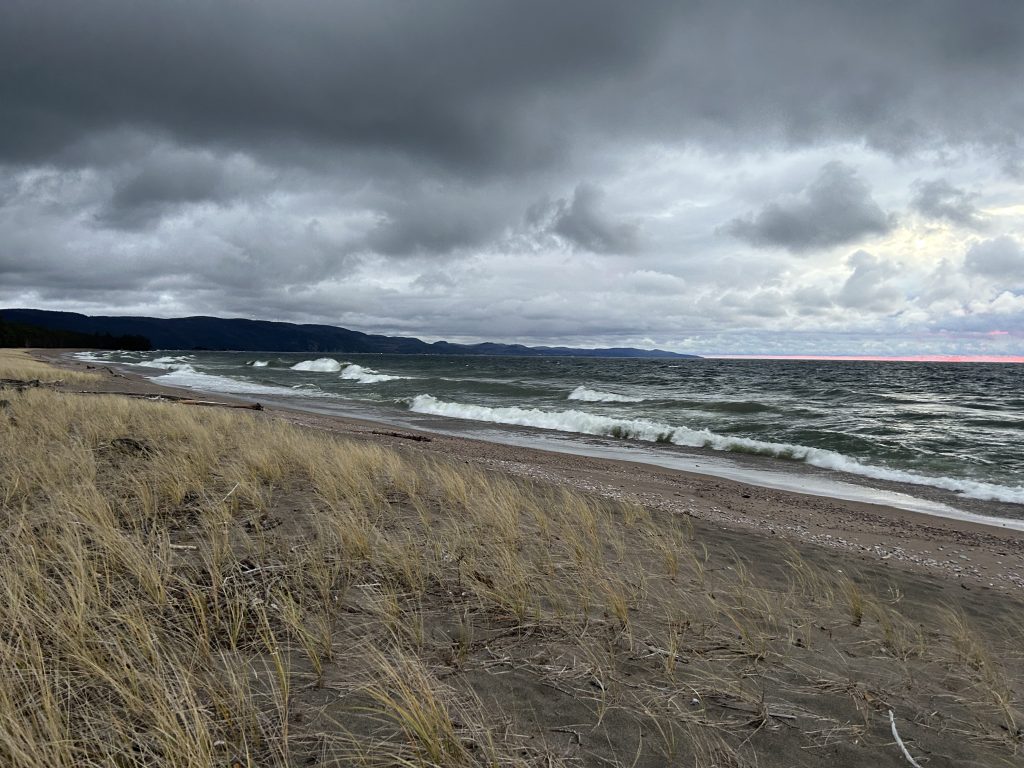 storm clouds over bay with waves crashing