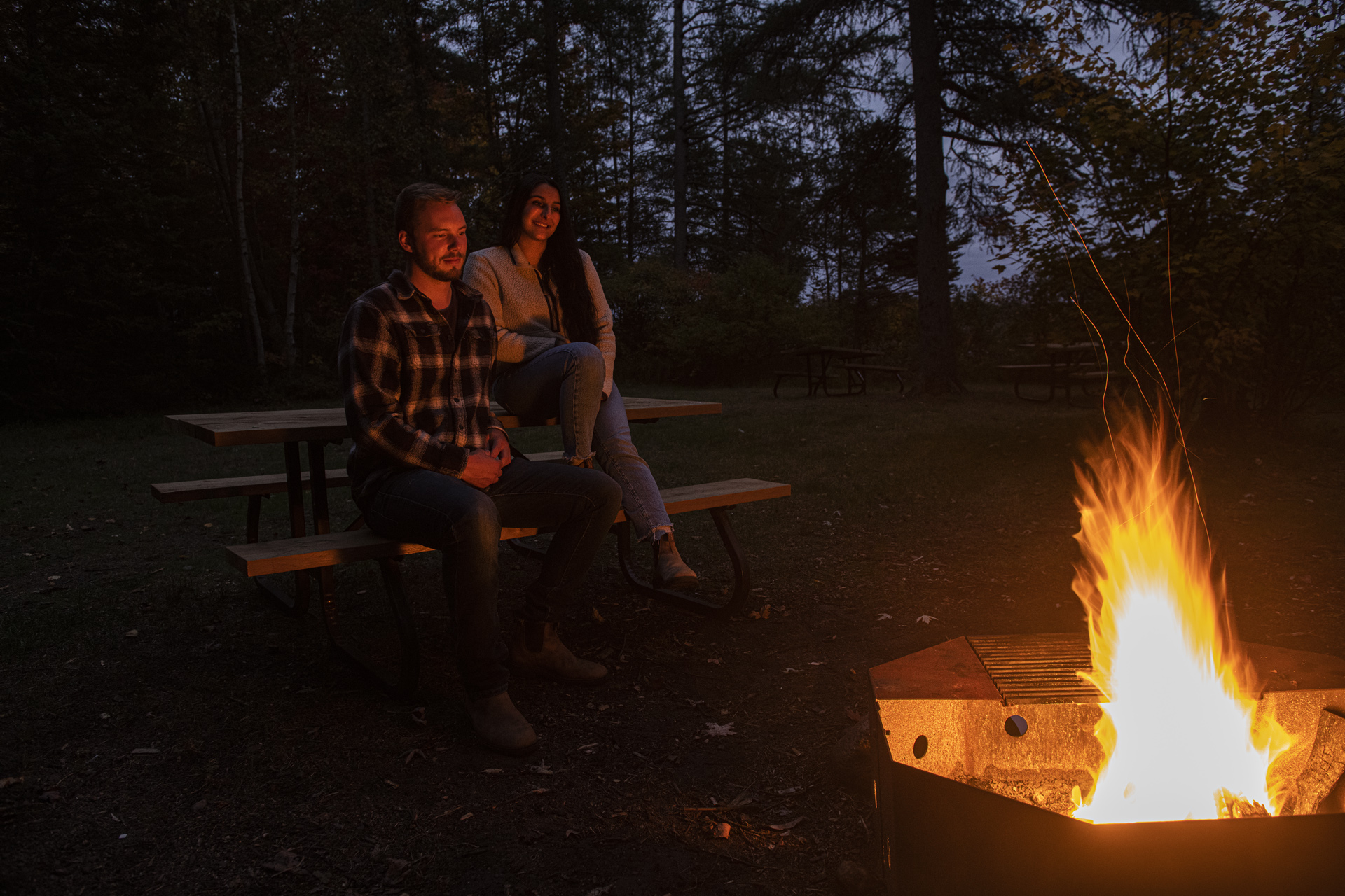 Couple enjoying campfire
