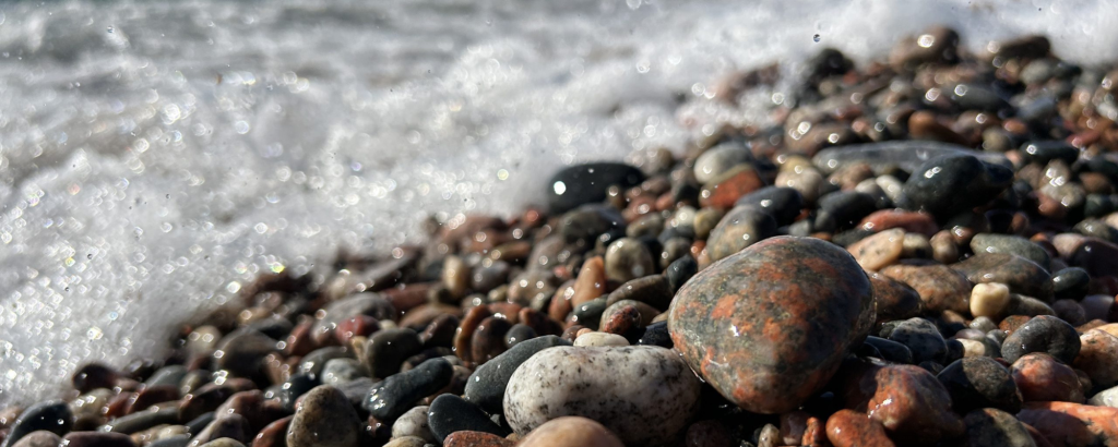 Colourful pebbles at Agawa Bay being splashed by Lake Superior waves