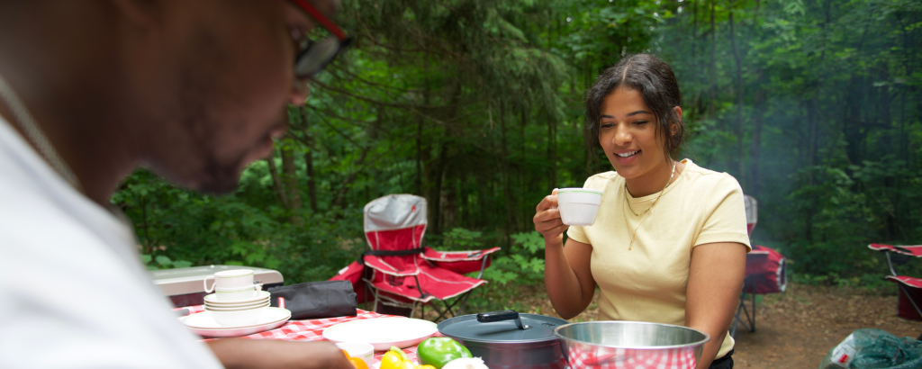 Two people having a picnic on a campsite