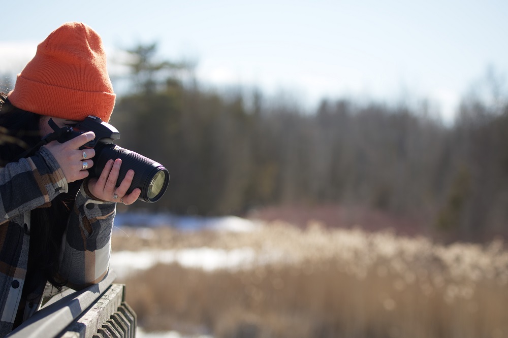 person taking photo from boardwalk