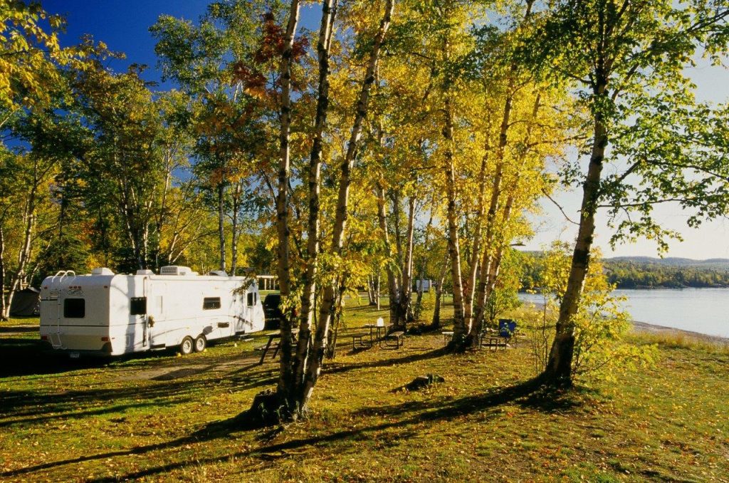 RV on waterfront campsite in fall