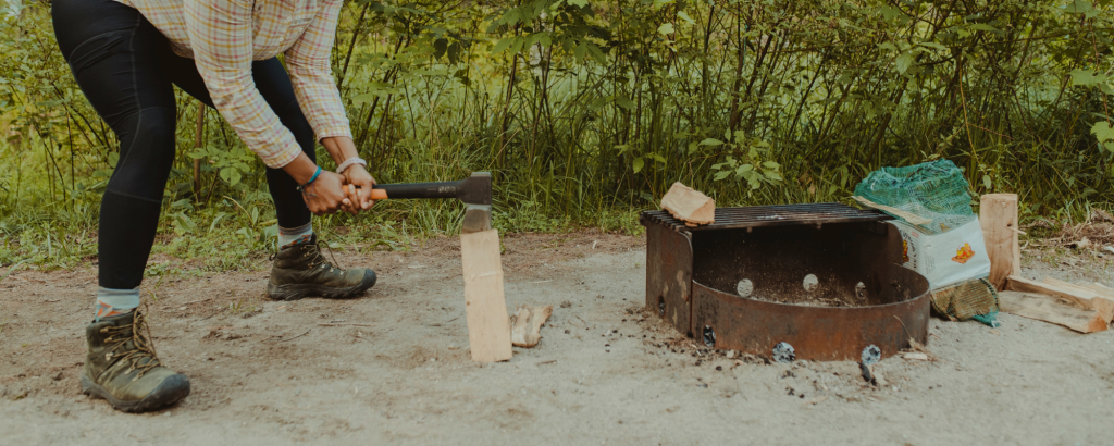 Person cutting wood with a hatchet