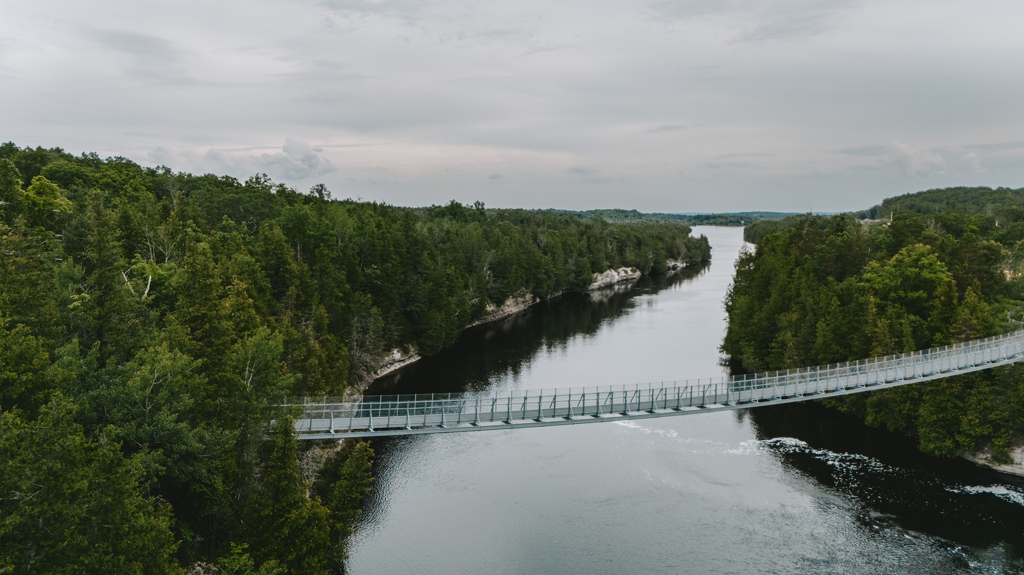 Bridge across river on a cloudy day