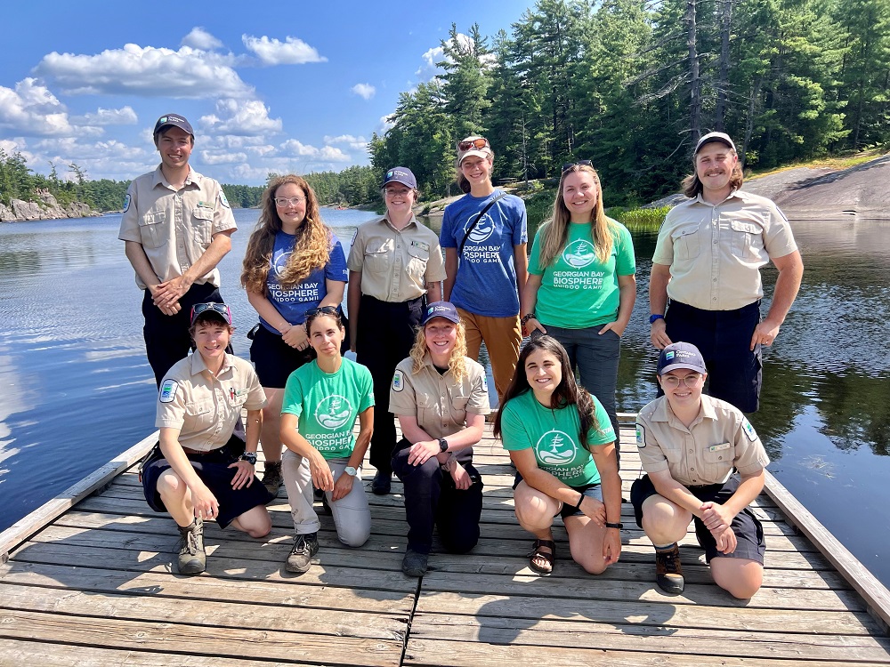 group of staff and volunteers posing together on dock