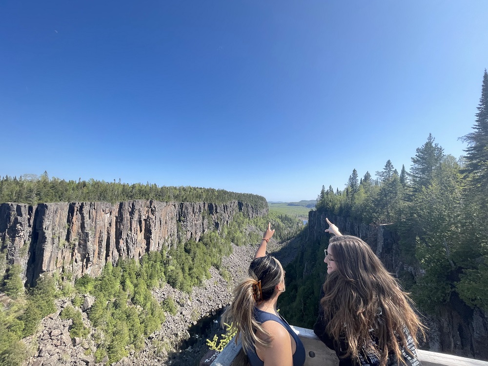 two people pointing at canyon