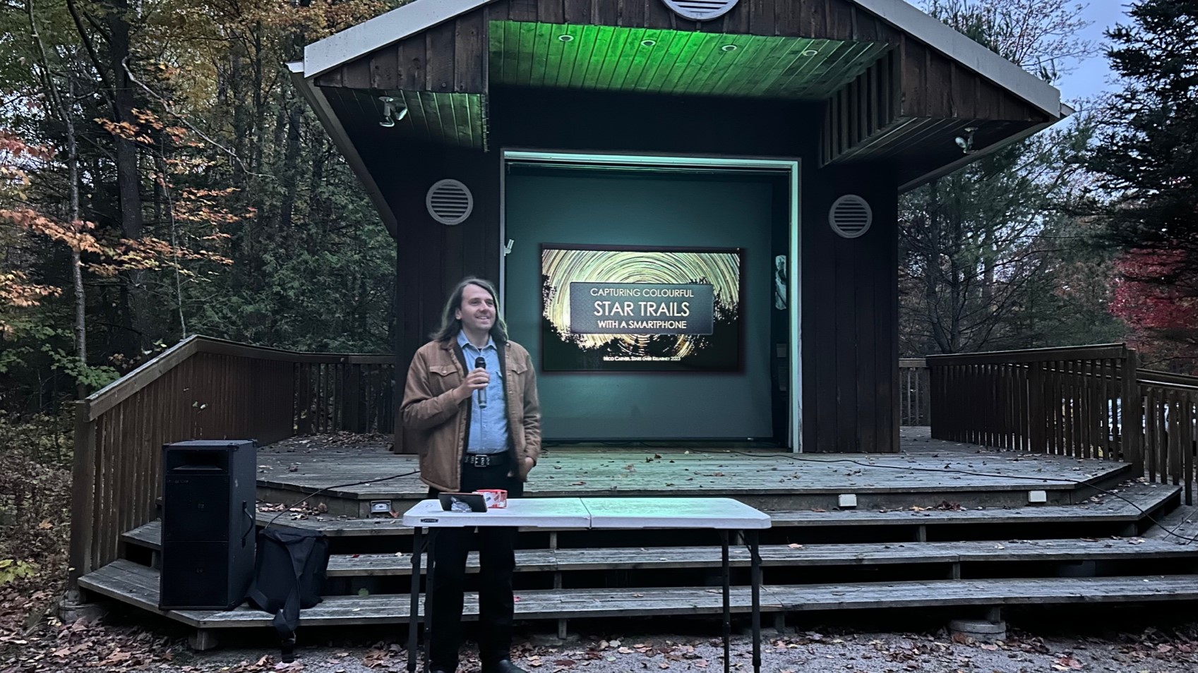 man presenting at amphitheatre at night