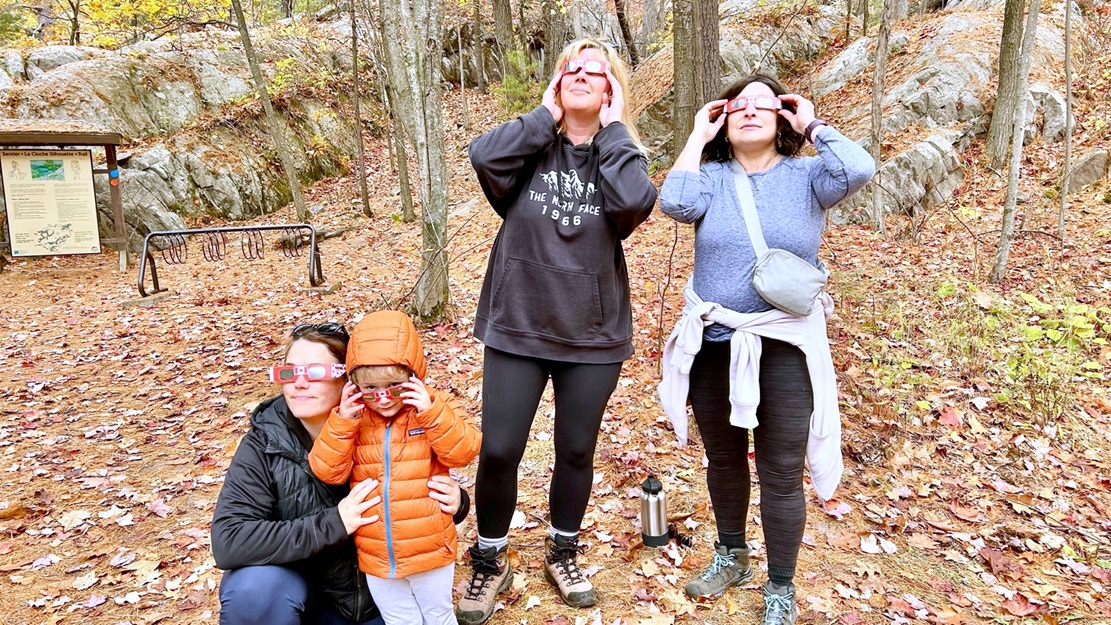 adults and child wearing safety glasses on trail