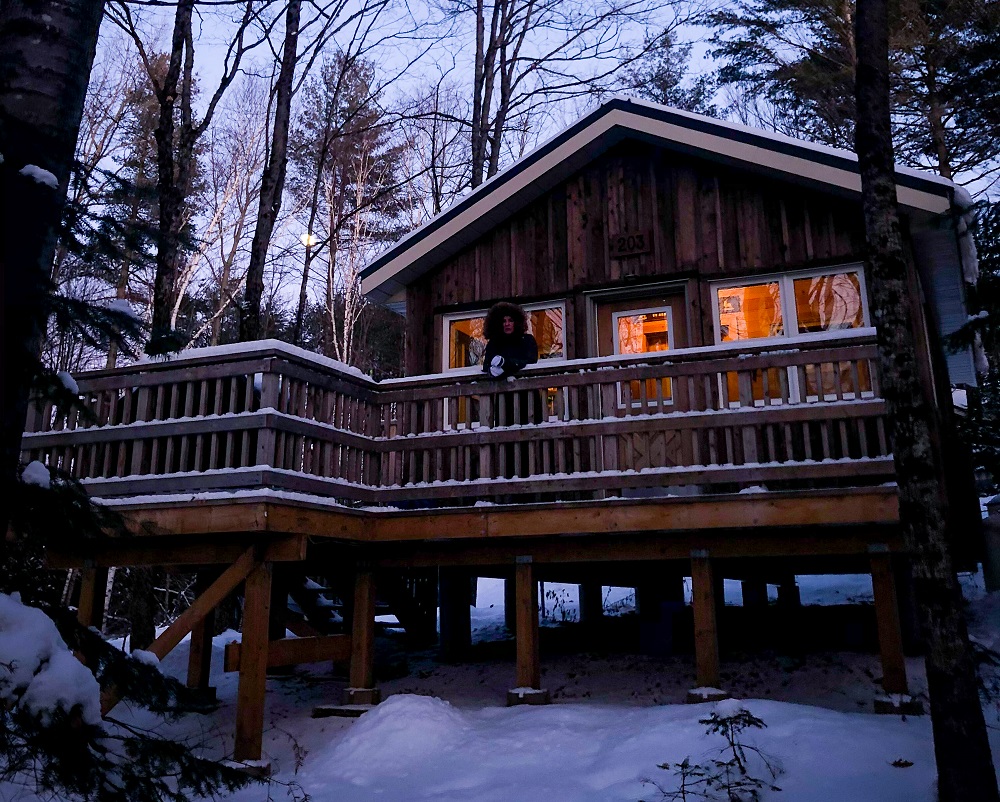 Cabin surrounded by snow.