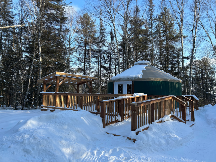snowcovered yurt with wooden porch