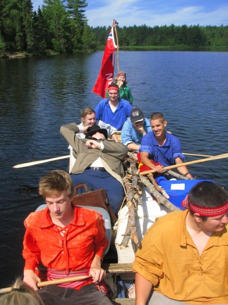 staff in canoe on lake