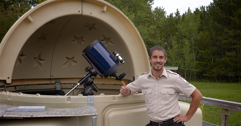 Dave standing beside the Kchi Waasa Debaabing observatory in Killarney Provincial Park