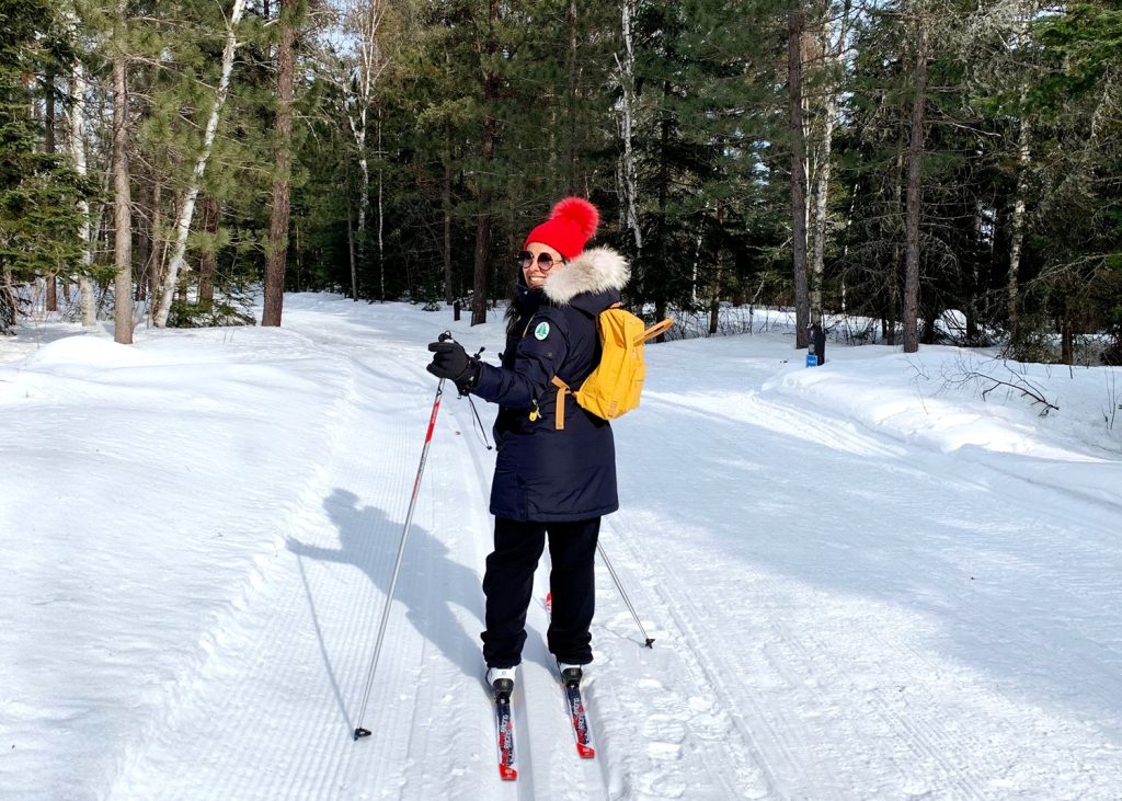 woman skiing in forest