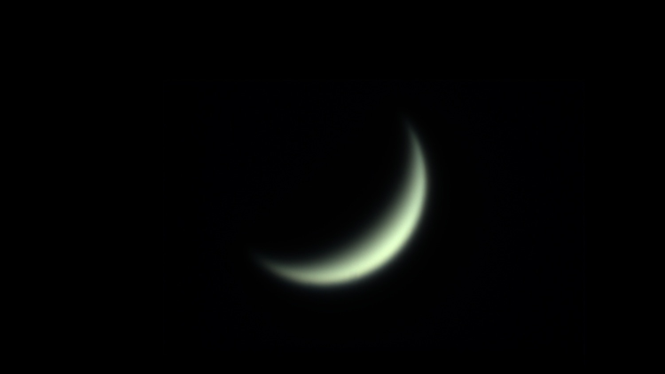 Venus in the sky, seen as a yellowy green crescent