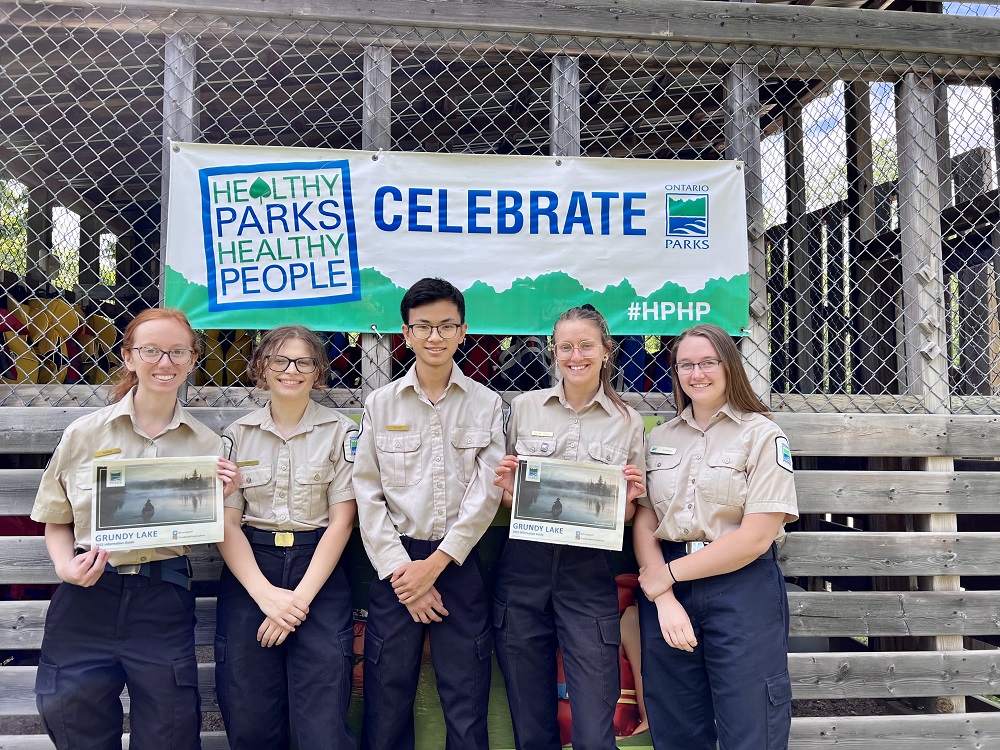 staff in front of HPHP banner