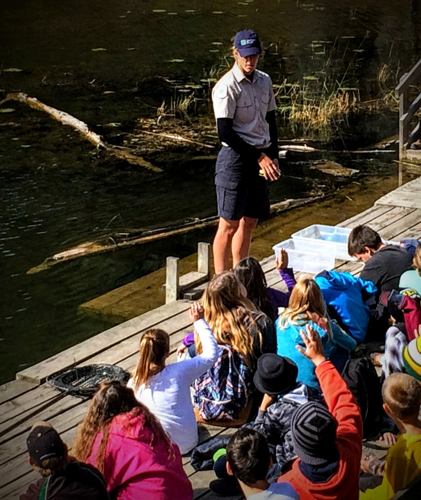 staff presenting in front of visitors on boardwalk