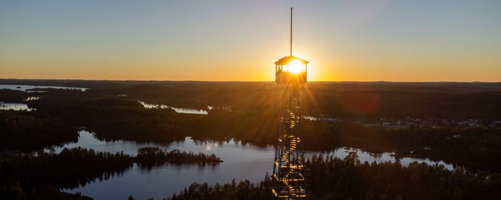 sunset over lake with firetower in foreground