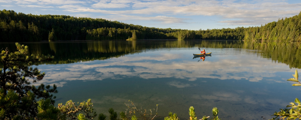 person canoeing on kettle lakes