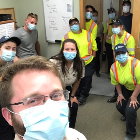 staff taking selfie wearing mask with other staff memebers