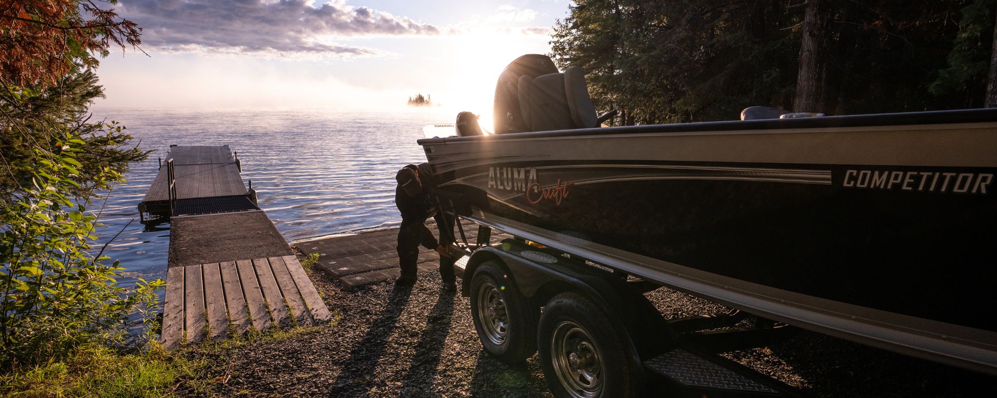 truck putting a fishing boat in the water at the boat launch