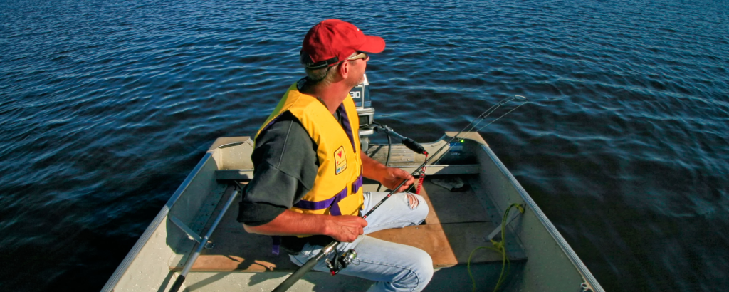 A fisherman in a boat on a lake
