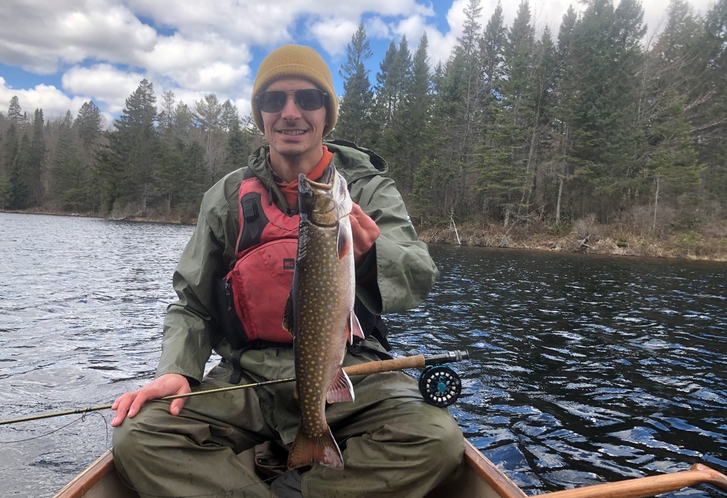 person in canoe holding Brook Trout 