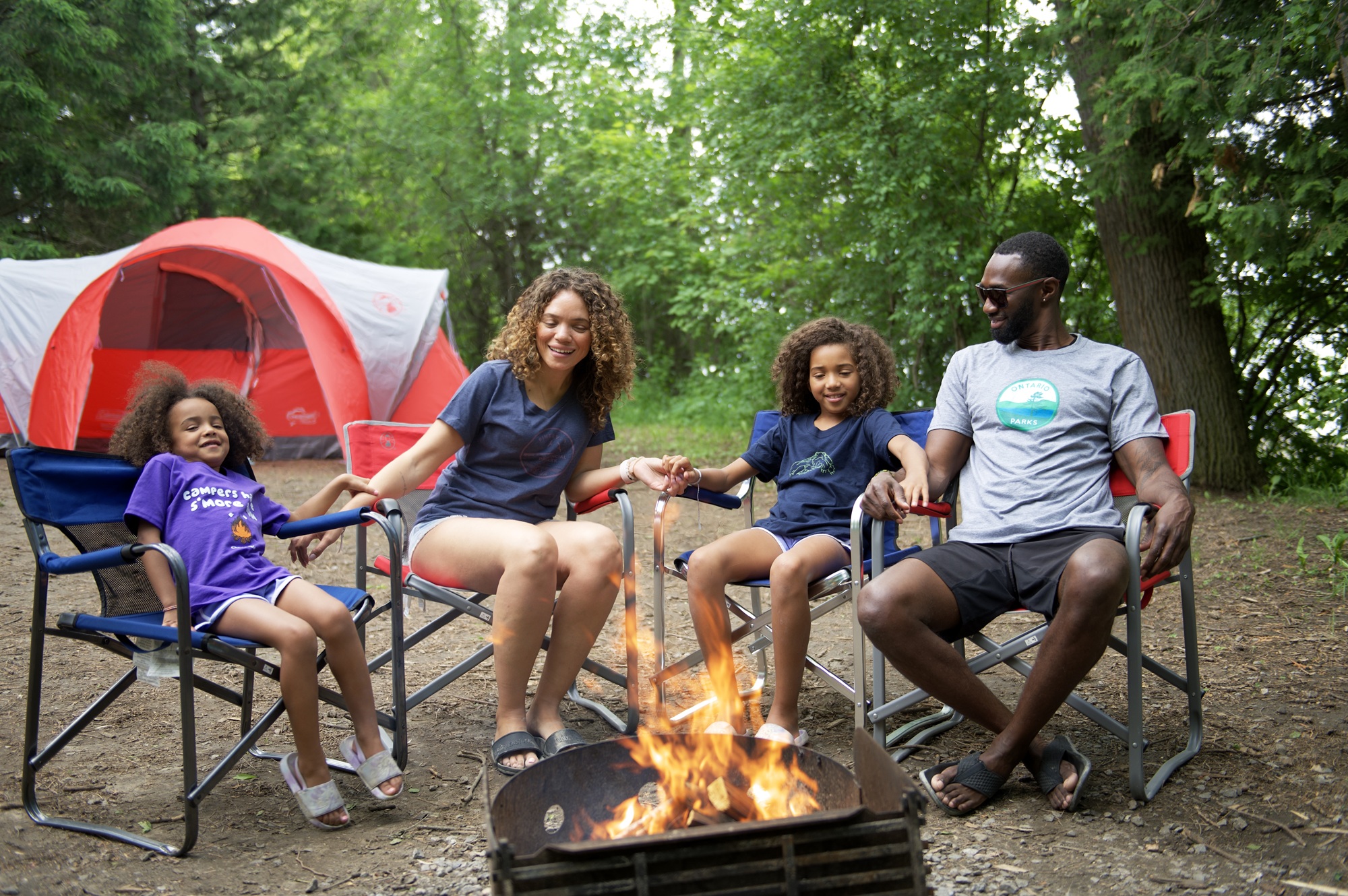 family sitting around campfire