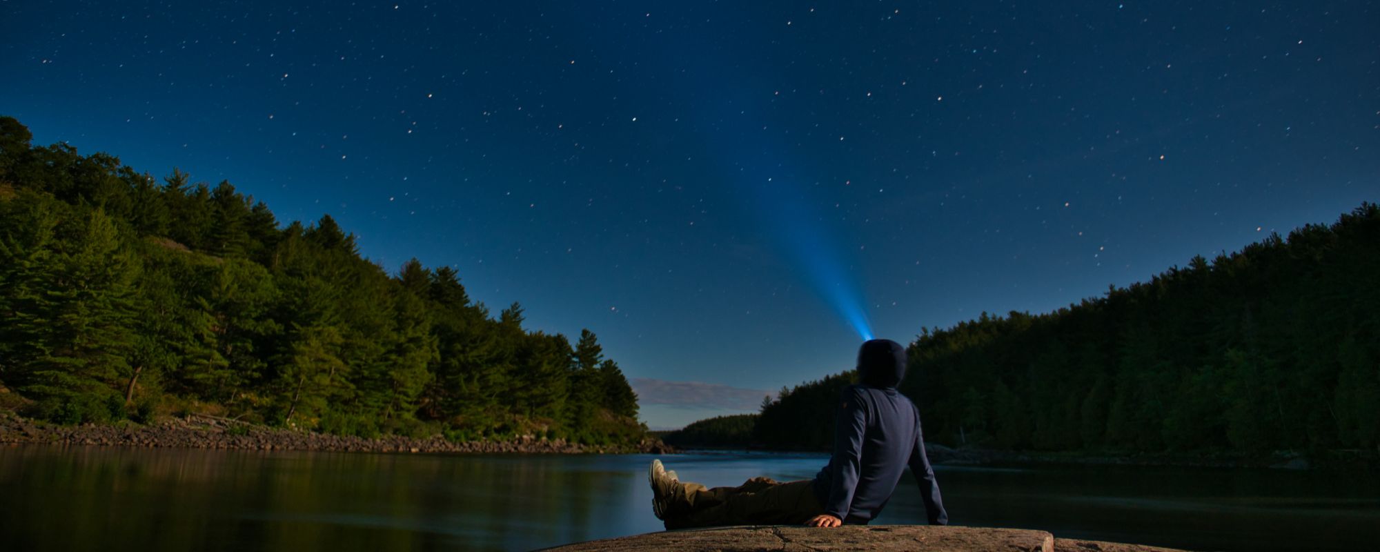 person stargazing with head lamp on