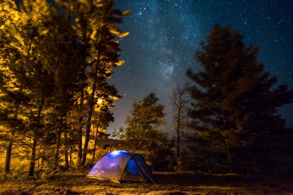 lit tent on campsite at night