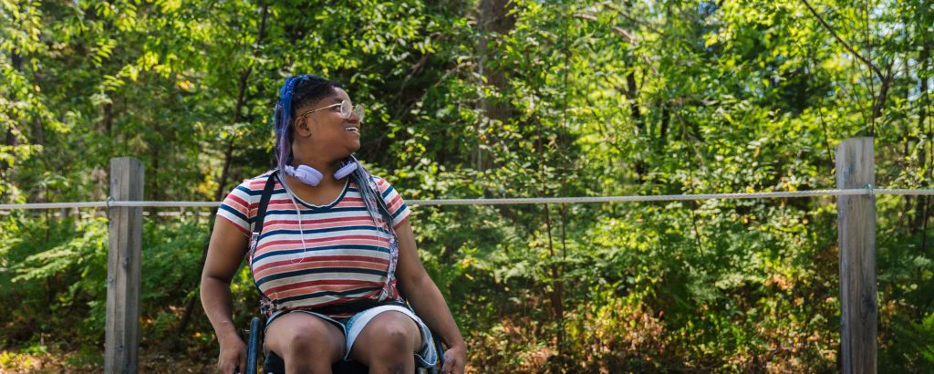 person in wheelchair on park trail
