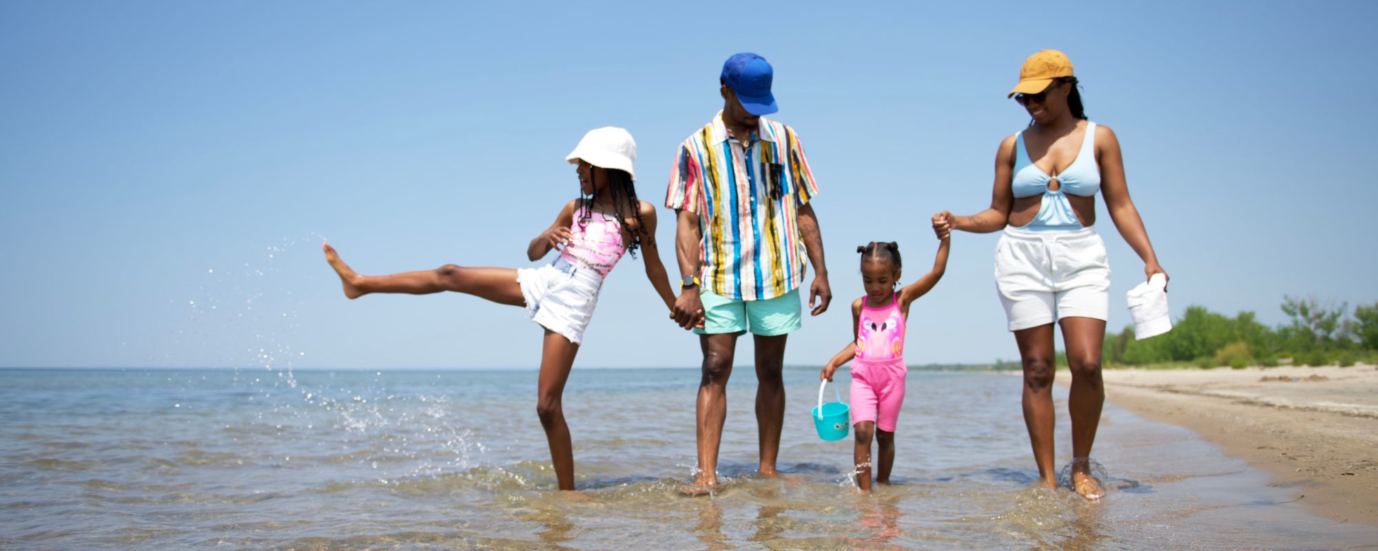 family walking along shoreline