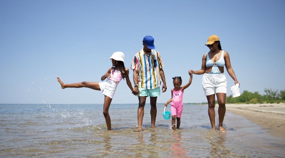 family walking along lakeshore