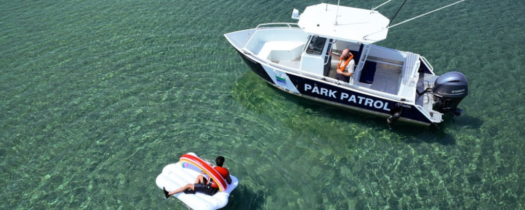 Aerial photo of a boat approaching a floatie in the open water