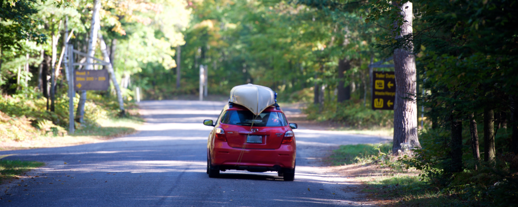 Car with canoe strapped to the roof