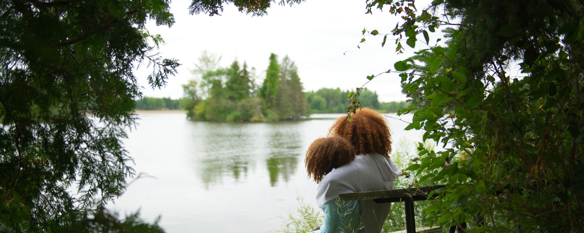 two children looking out at lake