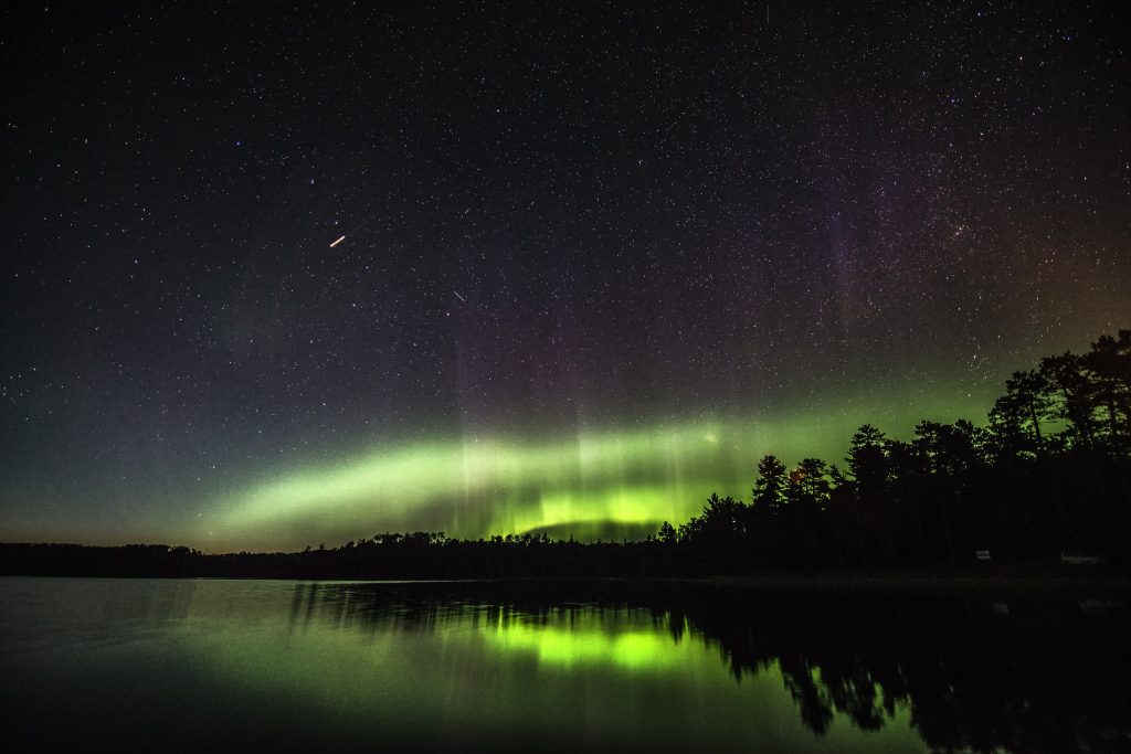 Northern Lights over lake and forest