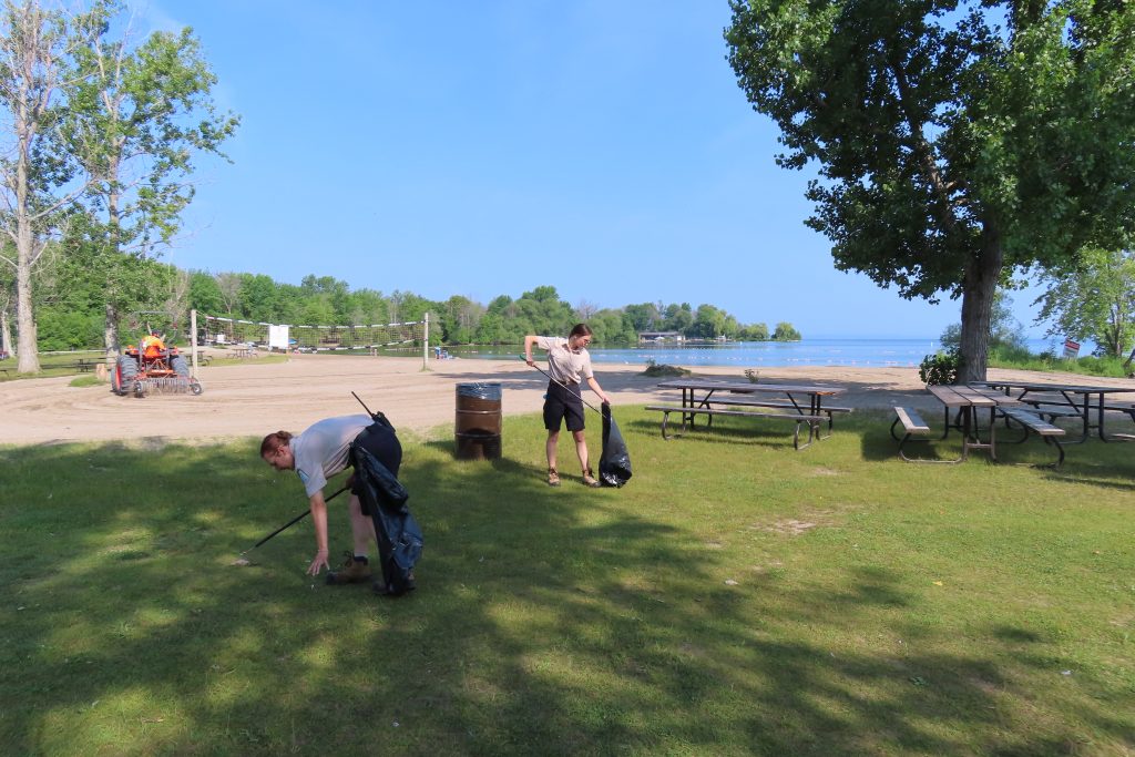 staff picking up trash in day use area