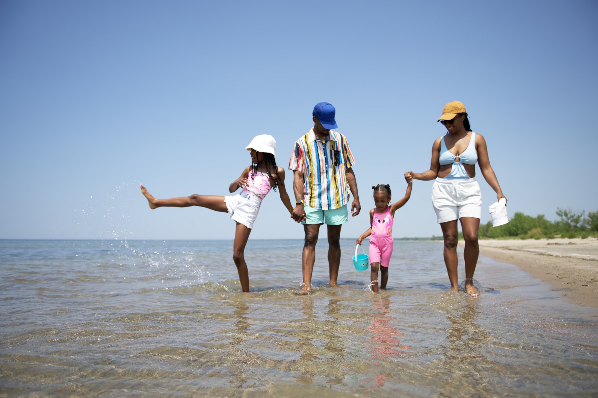 family walking along lakeshore