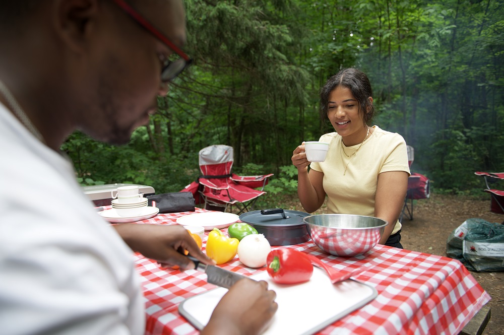 couple preparing for dinner on campsite