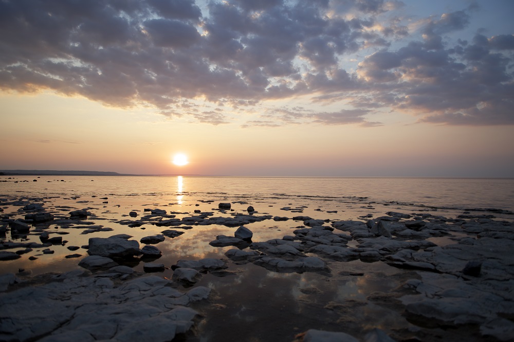 sunset over rocky beach